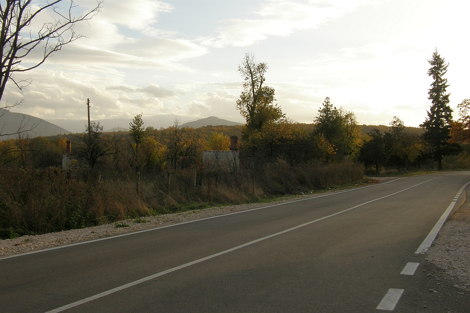 Paved Road Winds Through A Rural Landscape