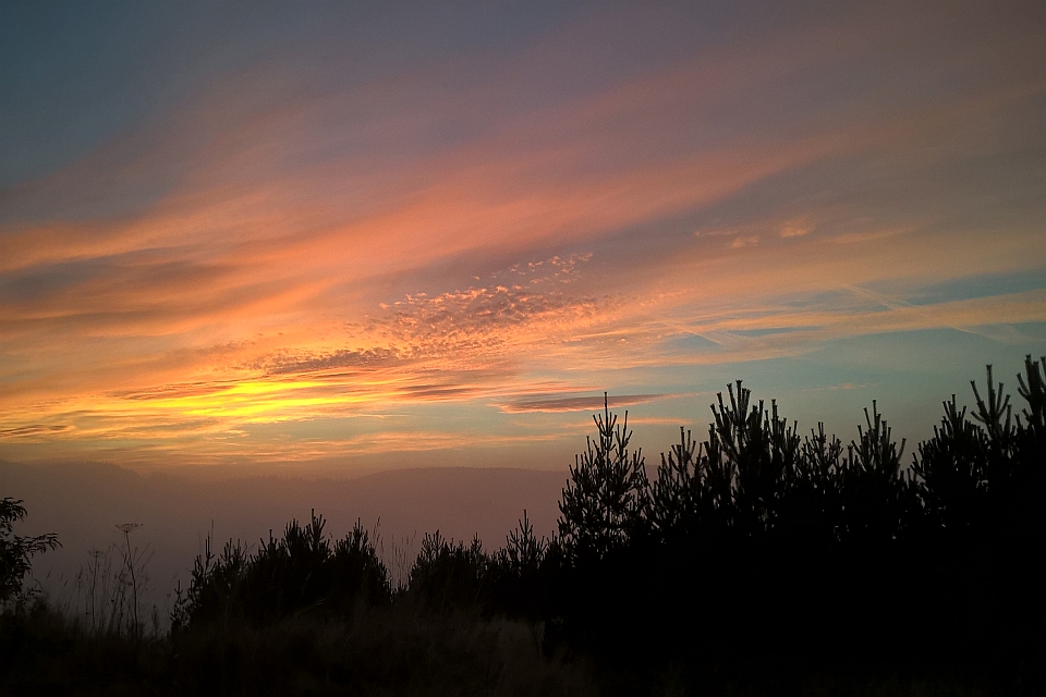 Sunset Over A Hazy Landscape