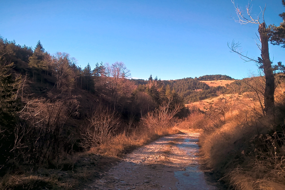 Dirt Road Winds Through A Mountainous Landscape