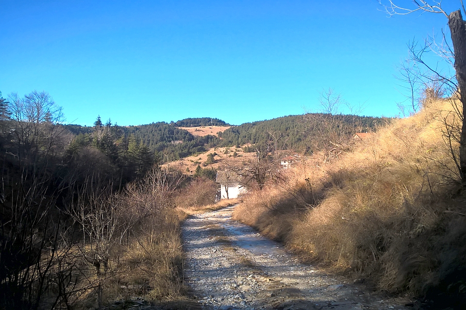 Dirt Road Winds Through A Mountainous Landscape