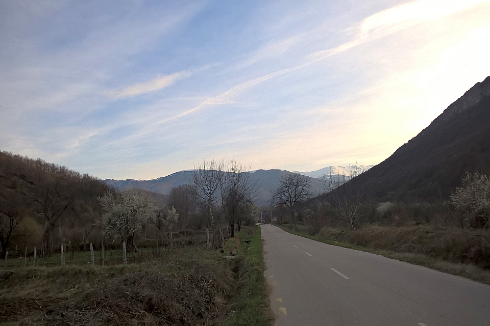 Paved Road Winds Through A Valley