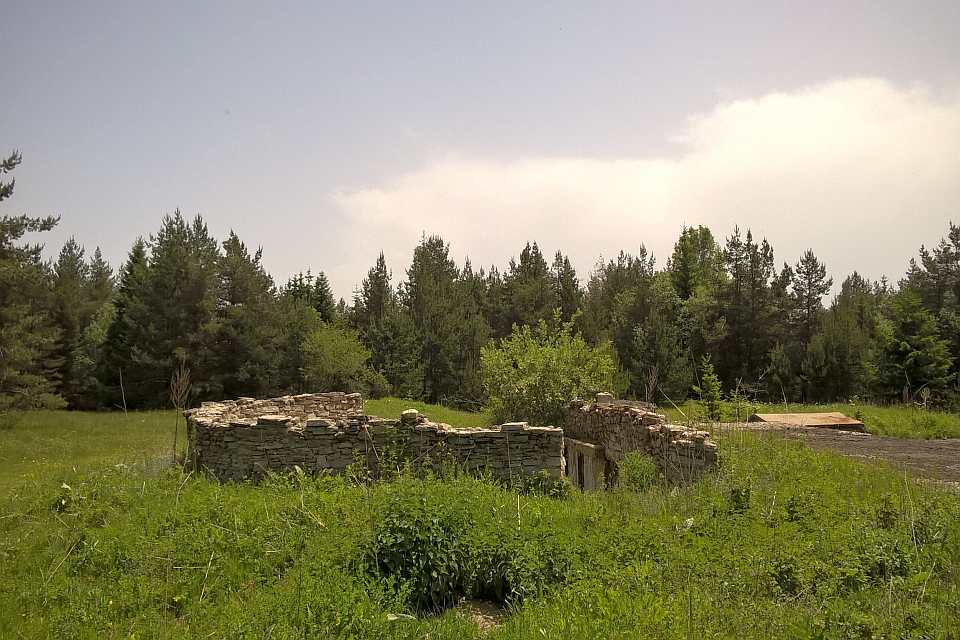 Stone Ruins In A Grassy Field