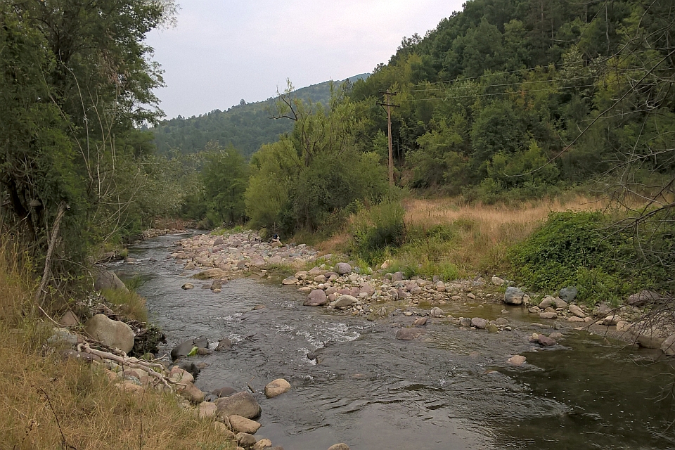 Rocky River Flows Through A Valley