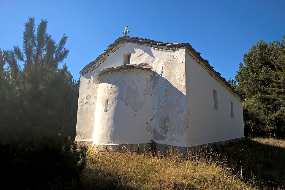 Whitewashed Stone Church Stands In A Field Of Tall Grass