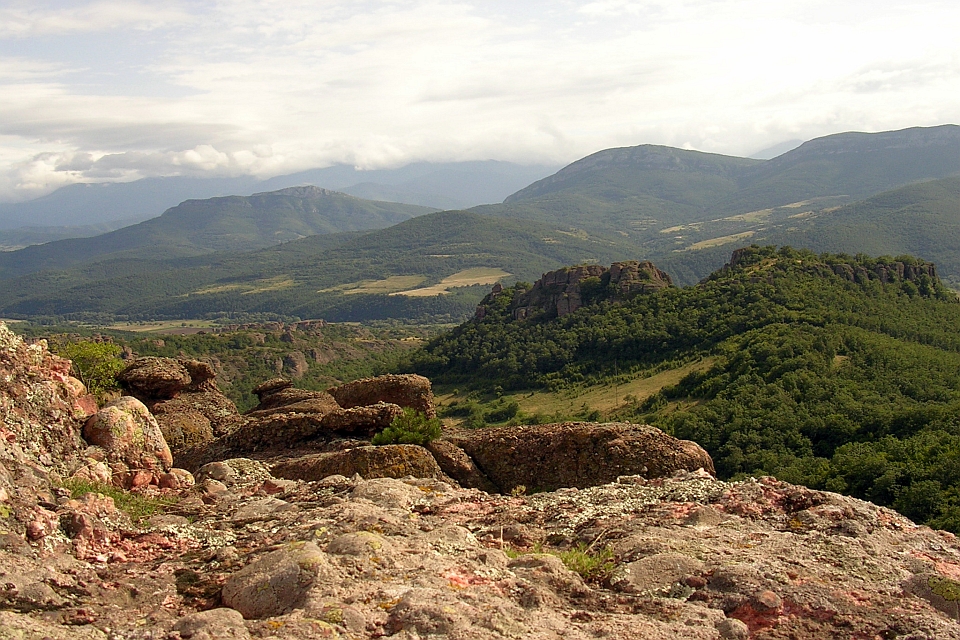 Rocky Outcrop Overlooking A Verdant Valley