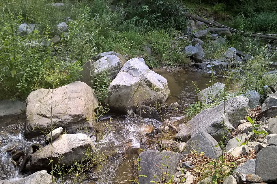 Small Stream Flows Through A Rocky Area