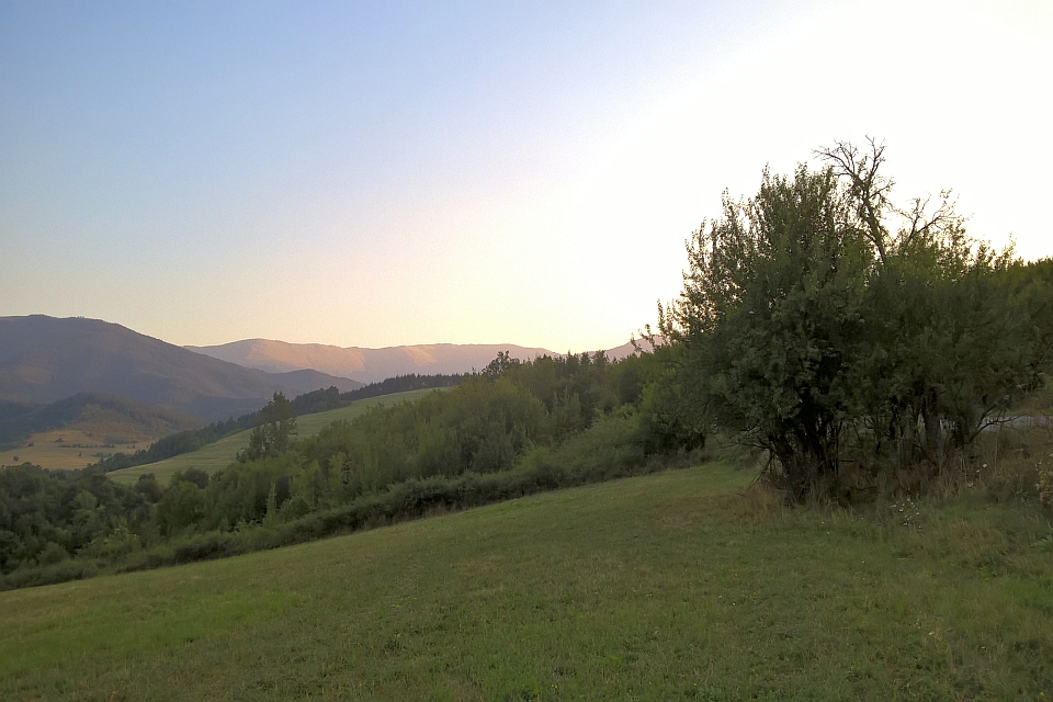 Sunset Over Rolling Hills And Green Pastures