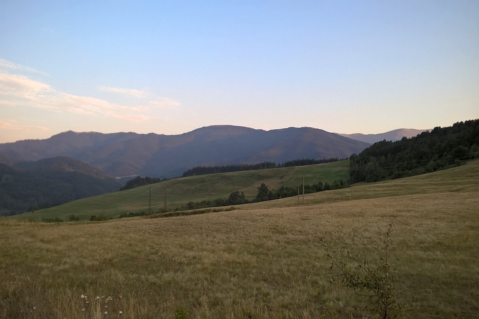 Rolling Hills And Mountains Under A Twilight Sky