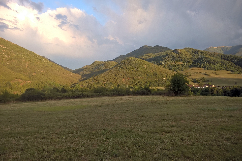 Rolling Green Hills Under A Partly Cloudy Sky