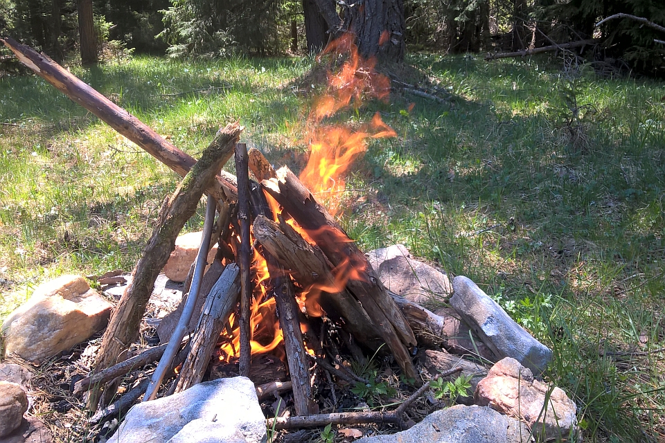 Campfire Burns Brightly Amidst A Ring Of Rocks