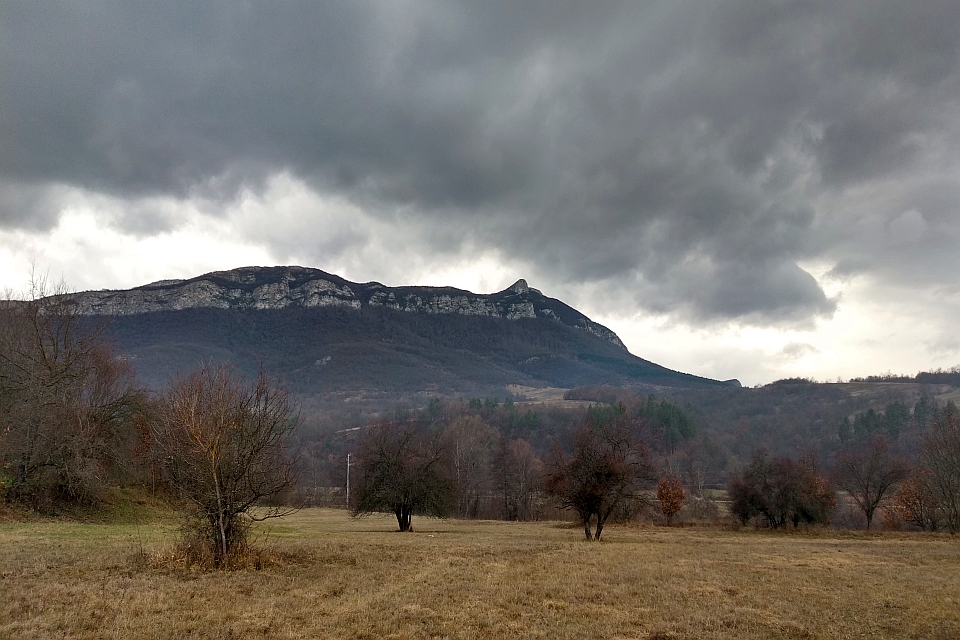 Large, Dark Mountain Under A Stormy Sky