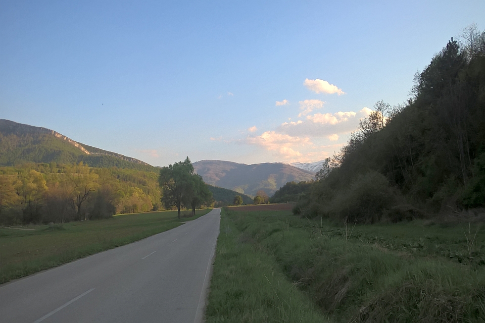 Paved Road Winds Through A Valley