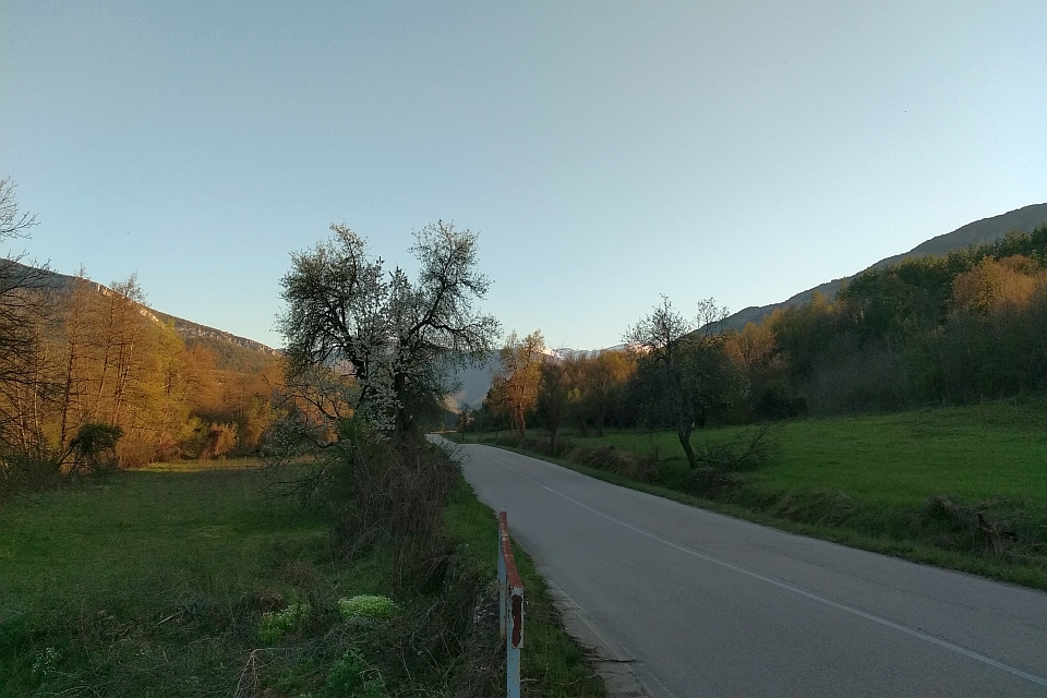 Paved Road Winds Through A Valley
