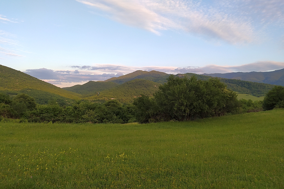 Green Field With Hills And Mountains