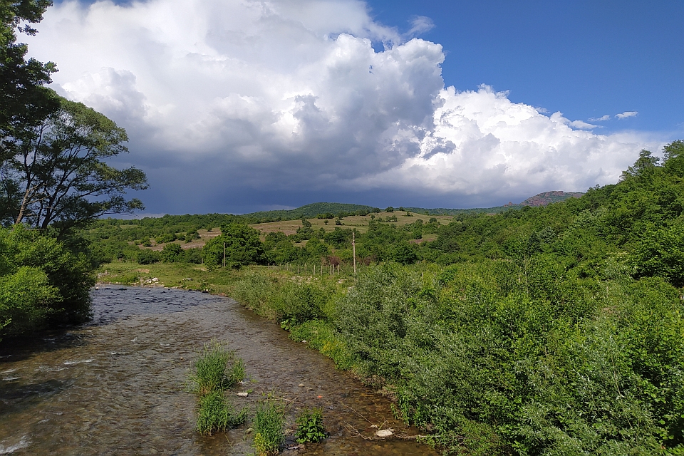 River Flows Through A Green Valley